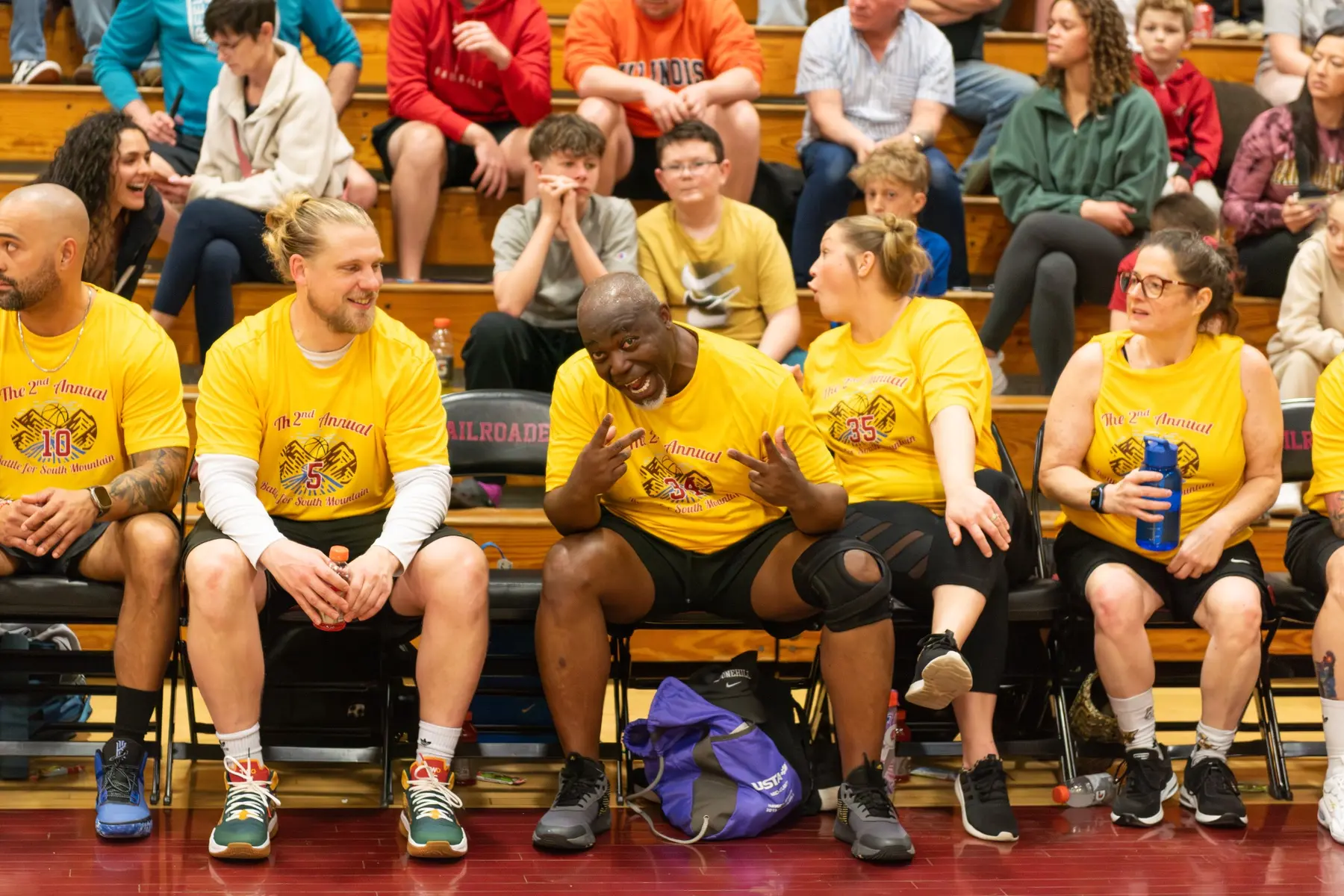Middletown players sharing a light moment on the bench during the 2025 game.
