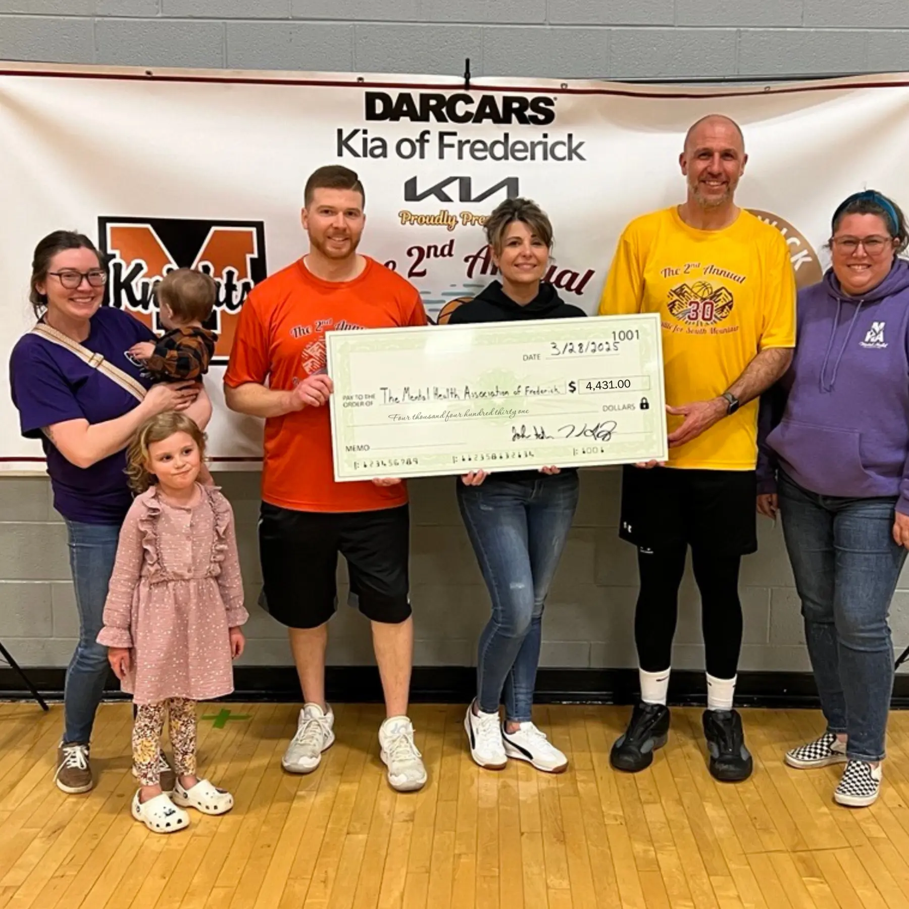The 2025 event presenting a $4,431 check to the Mental Health Association of Frederick.